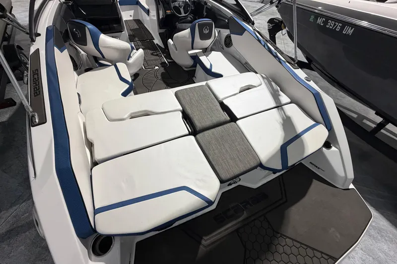 Slide: The Image of 2022 Scarab 195 ID boat interior with white and blue seating, modern design. - 14