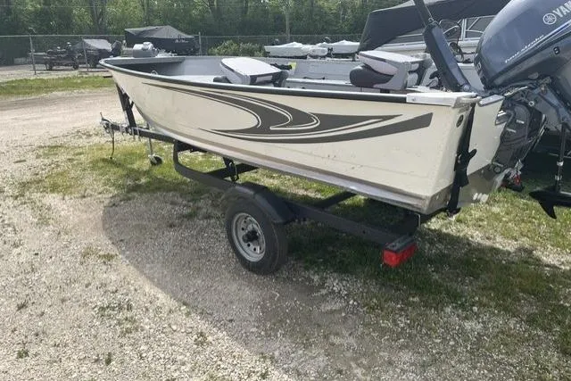 Slide: The Image of 2022 Smoker Craft Angler 14 T boat on trailer, parked outdoors. - 6