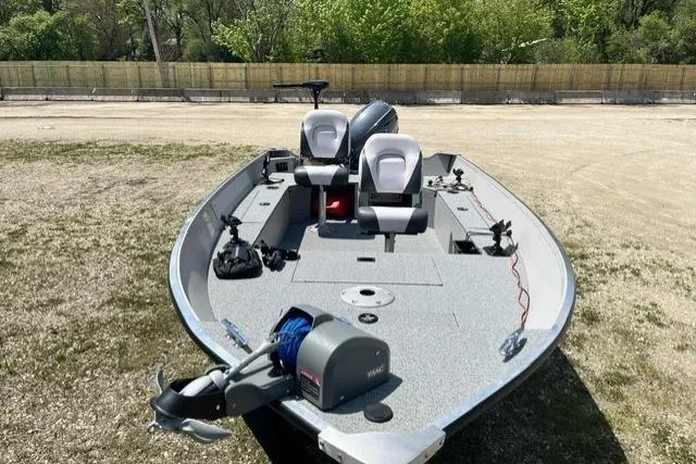Slide: The Image of 2022 Smoker Craft Angler 14 T boat with dual seats and motor, parked outdoors. - 9