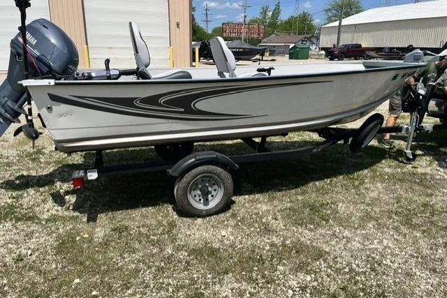 Slide: The Image of 2022 Smoker Craft Angler 14 T boat on trailer, parked outdoors. - 5