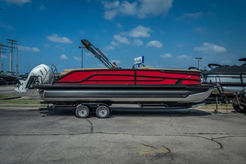 Slide: The Image of Red 2026 Evotti 525QL pontoon boat on trailer under blue sky. - 3