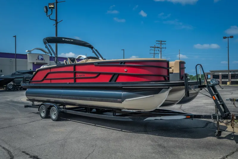 Slide: The Image of 2026 Evotti 525QL pontoon boat on trailer, vibrant red design, parked outdoors. - 1