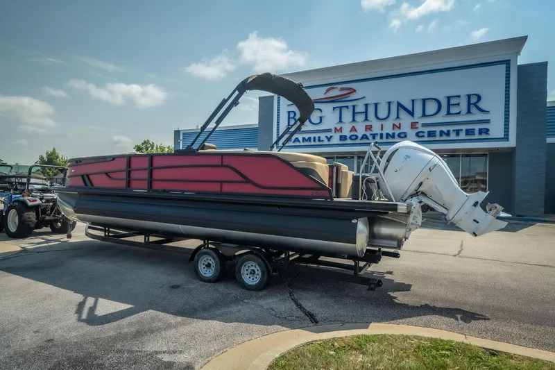 Slide: The Image of 2026 Evotti 525QL pontoon boat on trailer at Big Thunder Marine center. - 2