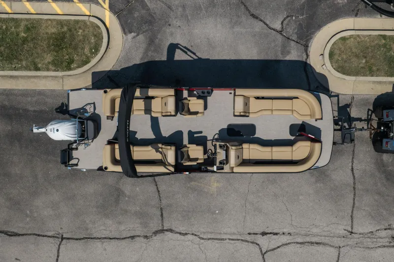 Slide: The Image of Aerial view of 2026 Evotti 525QL pontoon boat with beige seating on pavement. - 6