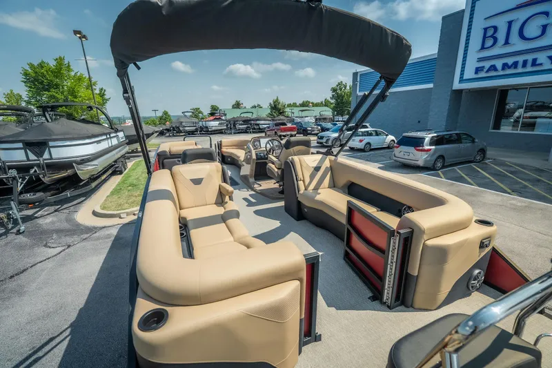Slide: The Image of 2026 Evotti 525QL pontoon boat with beige seating, parked at dealership. - 34