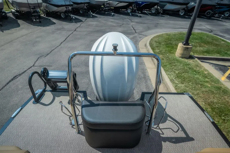 Slide: The Image of Rear view of 2026 Evotti 525QL boat with motor and docked boats in background. - 33