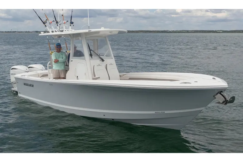 Slide: The Image of Manufacturer Provided Image: 2026 Regulator 28 boat on water with fishing rods and two people onboard. - 2