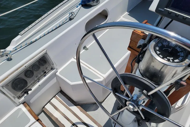 Slide: The Image of Cockpit of a 1986 Catalina 34 sailboat with steering wheel and navigation instruments. - 13