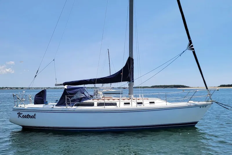 The Image of 1986 Catalina 34 sailboat named "Kestrel" on calm waters under a clear blue sky. - 0