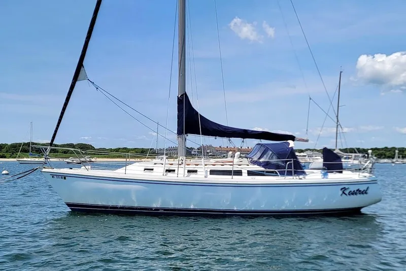 Slide: The Image of 1986 Catalina 34 sailboat on calm water under a clear blue sky. - 2