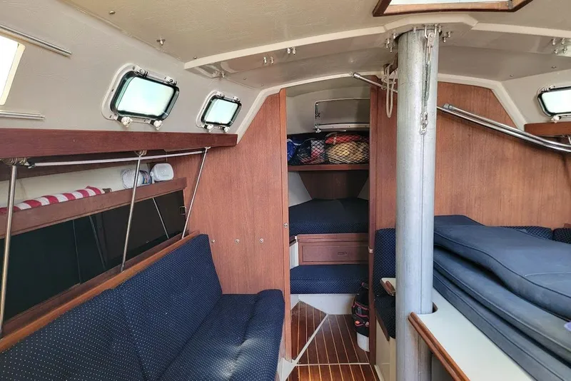 Slide: The Image of Interior of a 1986 Catalina 34 sailboat with cozy seating and wooden accents. - 5