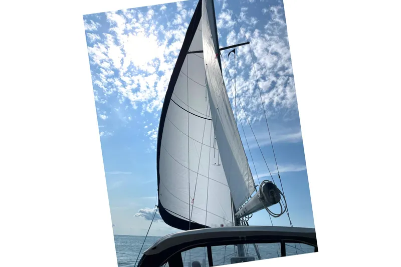 Slide: The Image of Sailing on a 1986 Catalina 34 MkII under a bright, partly cloudy sky. - 17