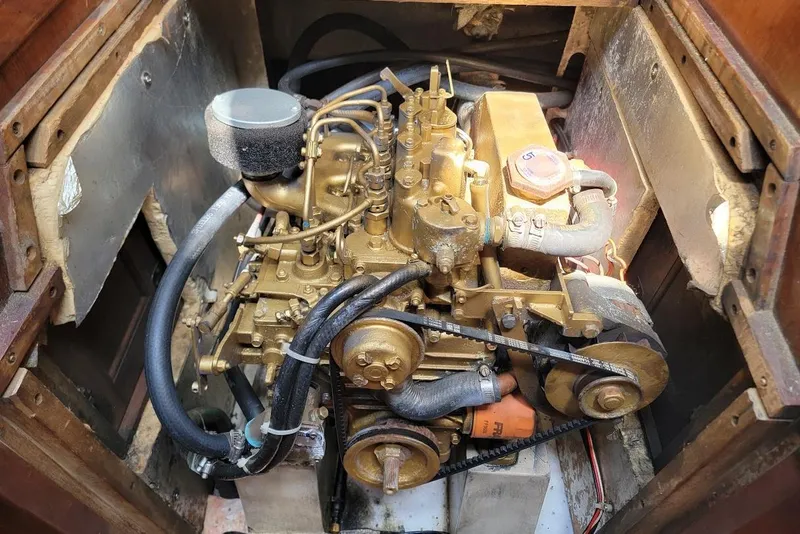 Slide: The Image of Engine compartment of a 1986 Catalina 34 sailboat, showcasing detailed mechanical components. - 11