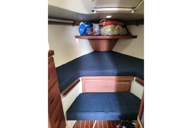 Slide: The Image of Cozy cabin interior of 1986 Catalina 34 sailboat with blue cushions and storage. - 6