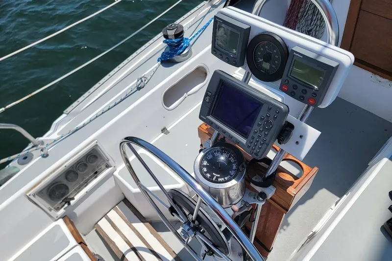 Slide: The Image of Cockpit of a 1986 Catalina 34 sailboat with navigation instruments and steering wheel. - 12