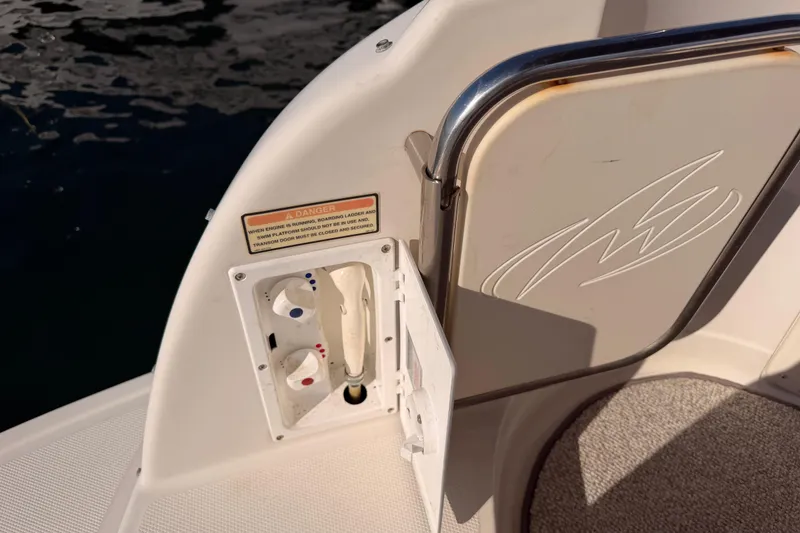 Slide: The Image of 2009 Monterey 250 Cruiser boat controls and safety warning near water. - 8
