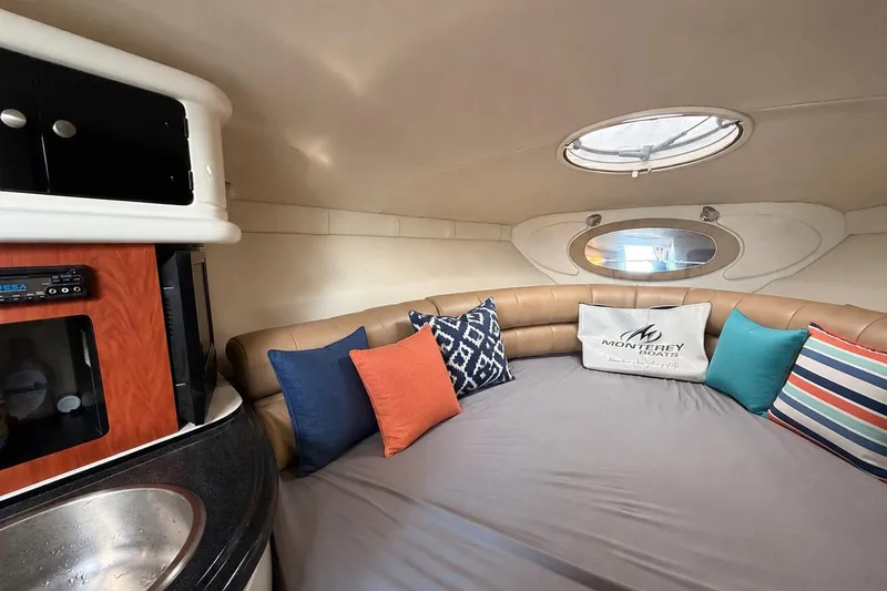 Slide: The Image of Interior of 2009 Monterey 250 Cruiser with cozy seating and colorful cushions. - 11