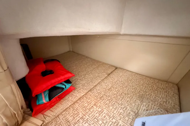 Slide: The Image of 2009 Monterey 250 Cruiser cabin interior with bedding and colorful pillows. - 15