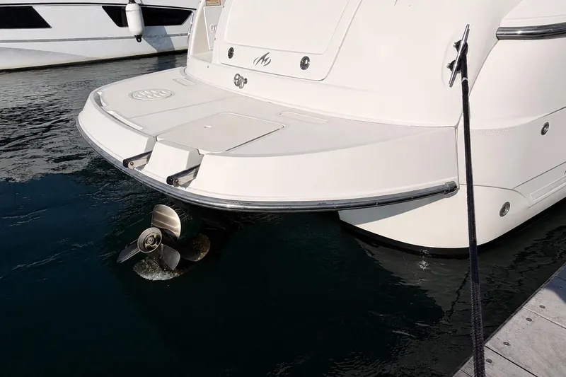 Slide: The Image of 2009 Monterey 250 Cruiser boat stern with propeller in marina. - 2