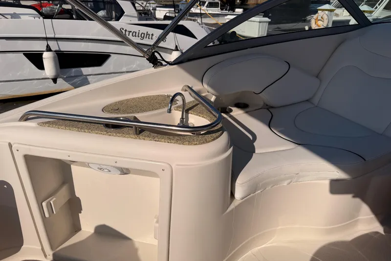 Slide: The Image of Interior of a 2009 Monterey 250 Cruiser boat with seating and sink area. - 9