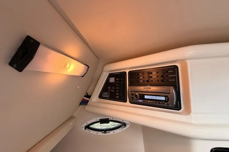 Slide: The Image of 2009 Monterey 250 Cruiser cabin interior with control panel and lighting. - 16