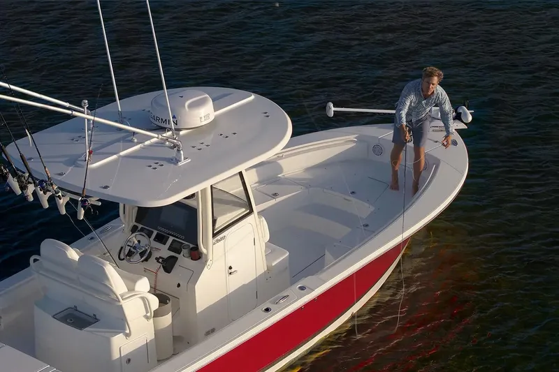 Slide: The Image of Manufacturer Provided Image: Man fishing on a 2026 Regulator 26XO boat in calm waters. - 4
