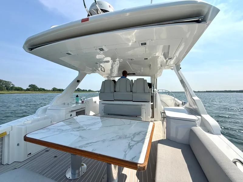 Slide: The Image of The 2019 Azimut Verve 40 features a sleek deck with a marble table and comfortable seating. - 3