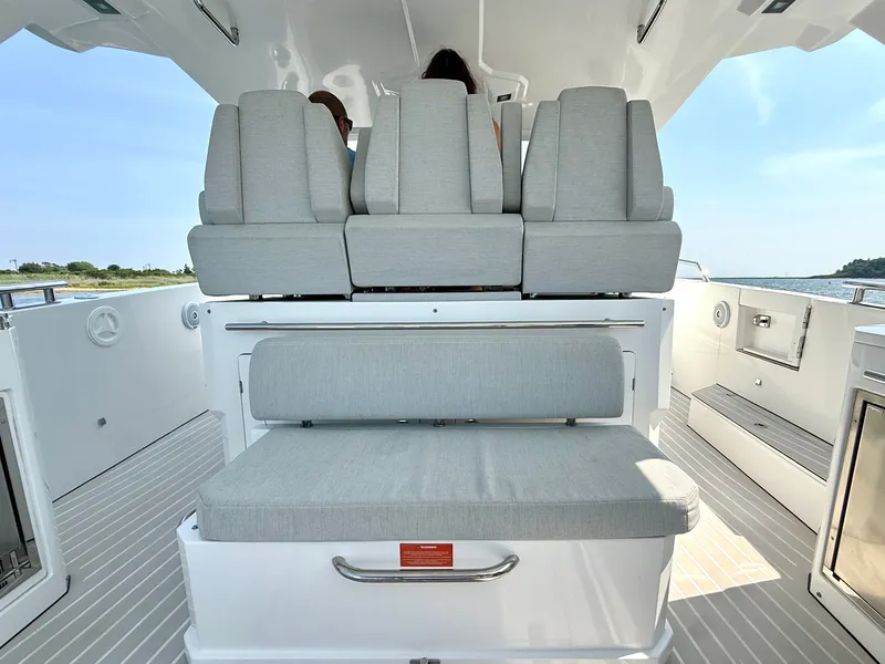 Slide: The Image of The 2019 Azimut Verve 40 features a stylish, modern seating arrangement with gray upholstery on the deck. - 12