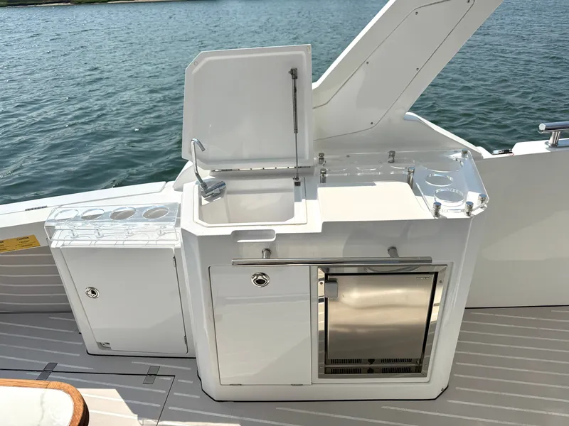 Slide: The Image of The 2019 Azimut Verve 40 features a sleek outdoor kitchen with a sink and refrigerator. - 7