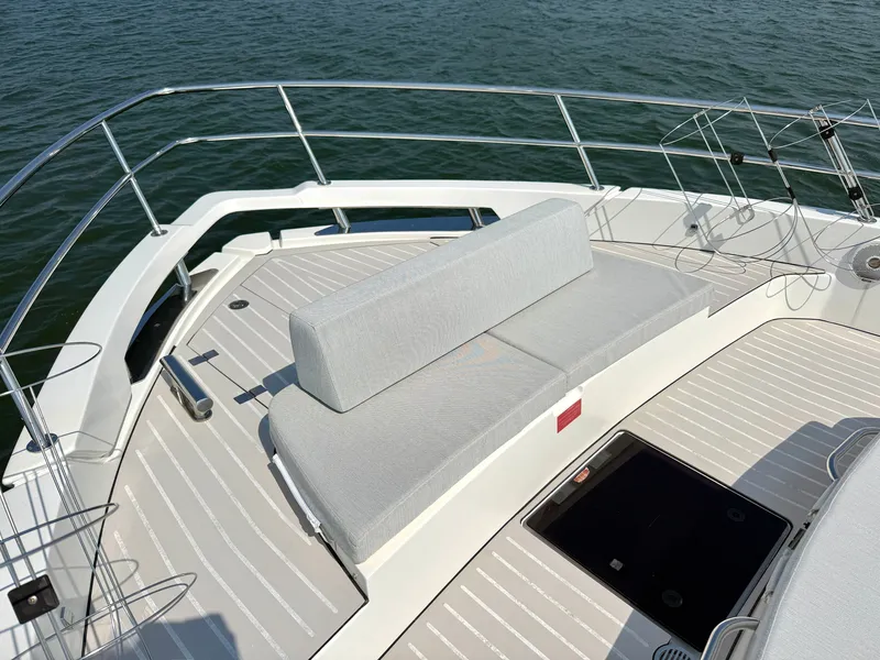 Slide: The Image of The image shows the foredeck of a 2019 Azimut Verve 40 with gray cushions. - 20
