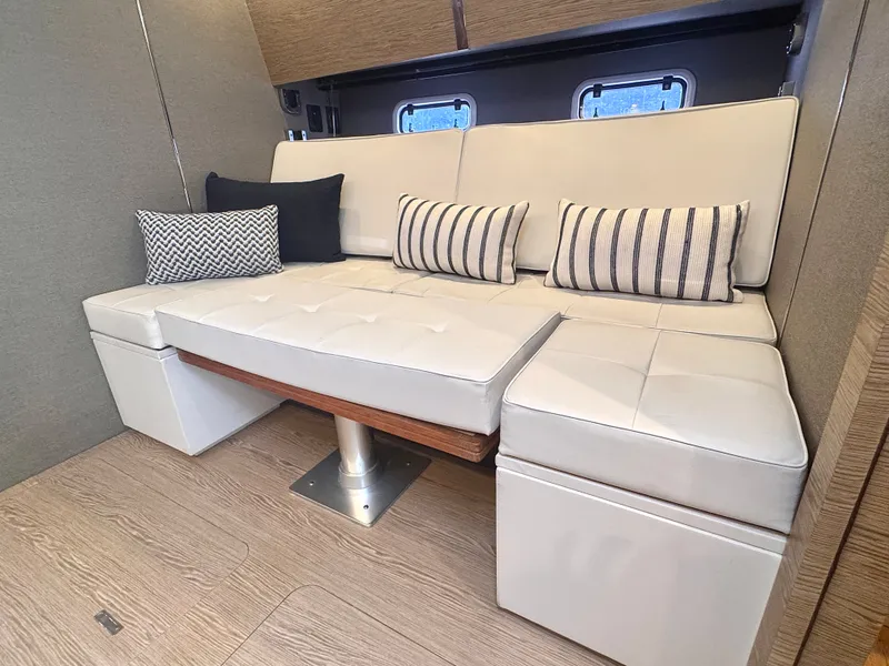 Slide: The Image of Interior of a 2019 Azimut Verve 40 with a cream sofa and striped cushions. - 30