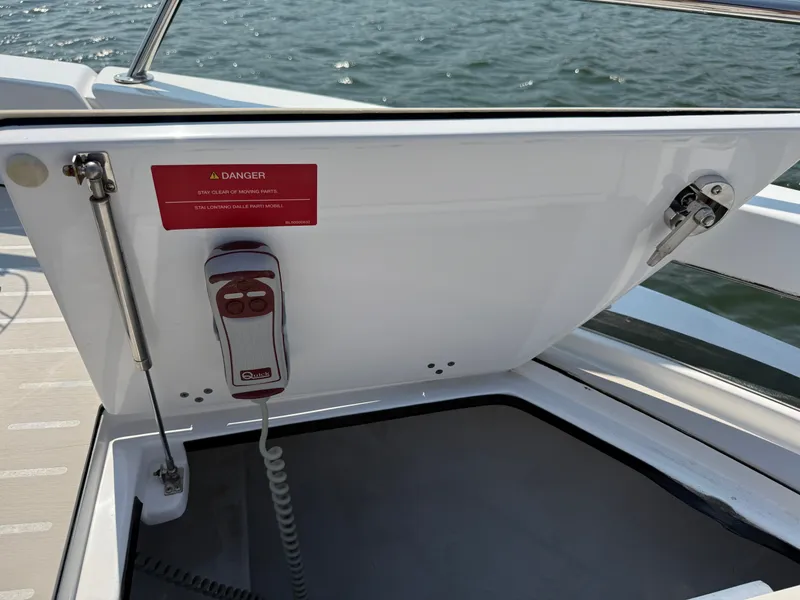 Slide: The Image of An open storage compartment on a boat with a warning sign and a control device. - 22
