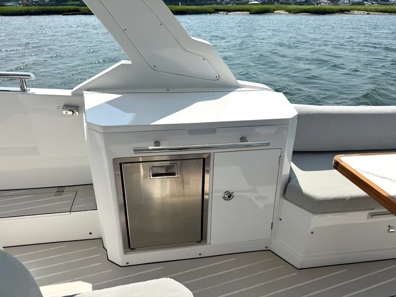 Slide: The Image of The 2019 Azimut Verve 40 features a sleek outdoor kitchen with stainless steel grill and seating area. - 8