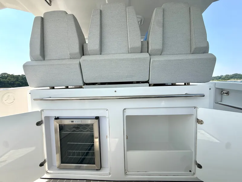 Slide: The Image of The image shows the seating area of a 2019 Azimut Verve 40 boat with gray upholstery and a built-in fridge. - 13