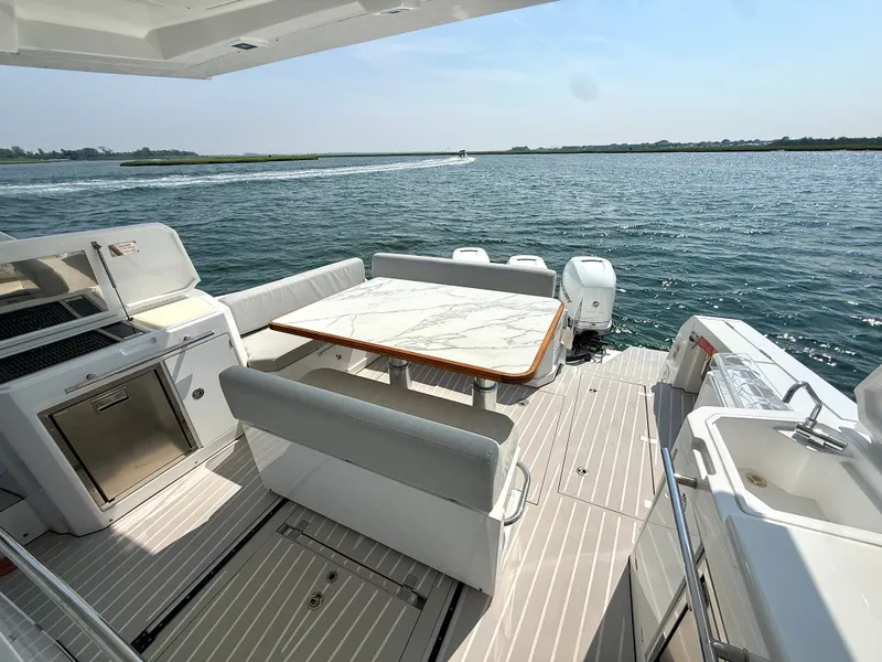 Slide: The Image of The image shows the stern of a 2019 Azimut Verve 40 with a stylish dining area. - 6