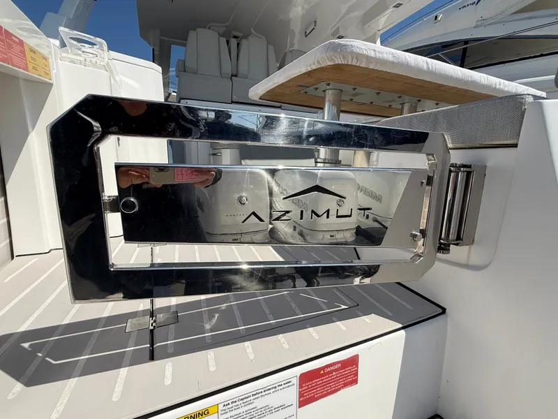 Slide: The Image of The image shows a shiny metal plate with the Azimut logo on a boat. - 27