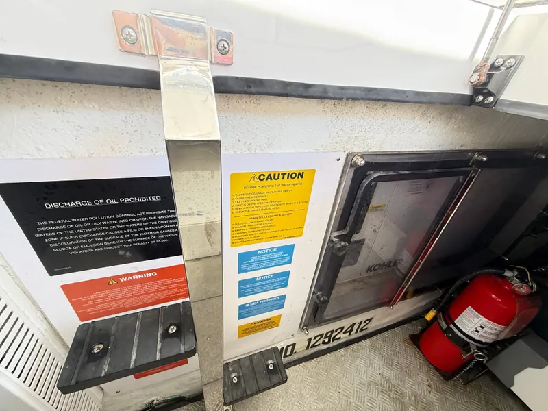 Slide: The Image of A section on a boat featuring safety and warning notices, along with a fire extinguisher. - 39