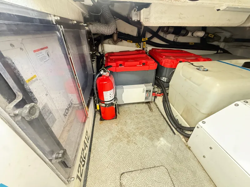 Slide: The Image of The engine room of a 2019 Azimut Verve 40 shows batteries and a fire extinguisher. - 37
