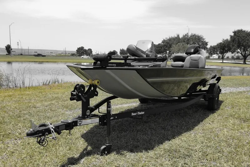 The Image of 2026 Bass Tracker boat on trailer by a lake, ready for fishing adventures. - 0