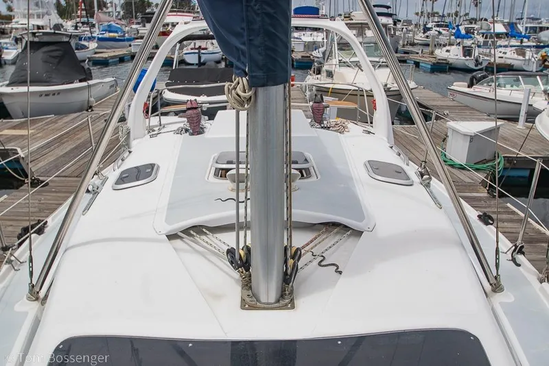 Slide: The Image of Hunter 340 sailboat deck view, 1999 model, docked at a marina with other boats. - 32