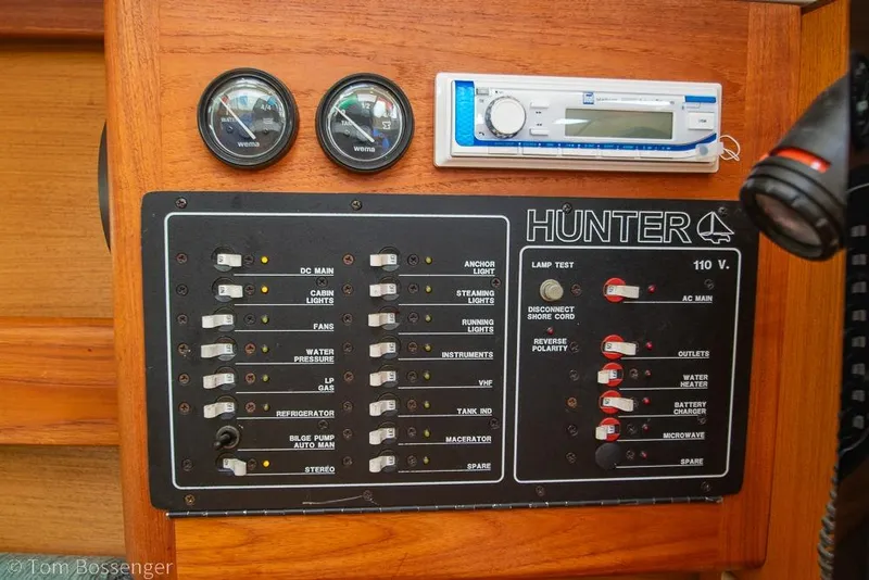 Slide: The Image of Control panel of a 1999 Hunter 340 sailboat with gauges and switches. - 21
