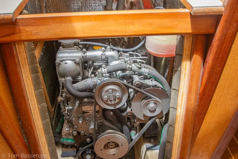 Slide: The Image of Engine compartment of a 1999 Hunter 340 sailboat, showcasing mechanical components and belts. - 38