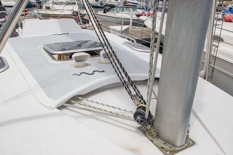 Slide: The Image of Deck view of a 1999 Hunter 340 sailboat, featuring rigging and hatch details. - 33