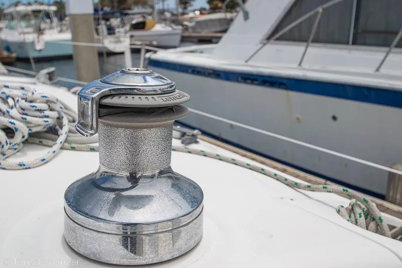 Slide: The Image of Winch on 1999 Hunter 340 sailboat deck, with ropes and marina background. - 28