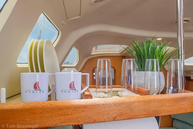 Slide: The Image of Interior of a 1999 Hunter 340 yacht with mugs, glasses, and decor. - 13