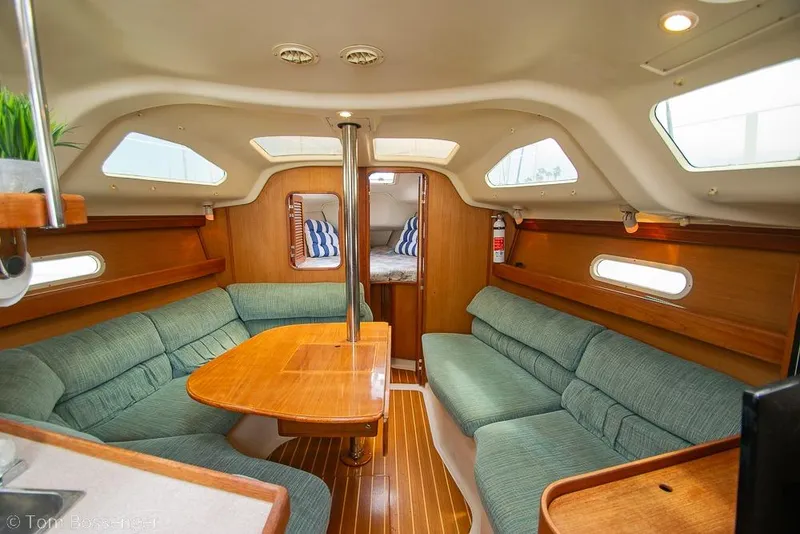 Slide: The Image of Interior of a 1999 Hunter 340 sailboat with cozy seating and wooden finishes. - 14