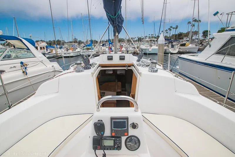 Slide: The Image of Cockpit view of a 1999 Hunter 340 sailboat docked in a marina. - 6