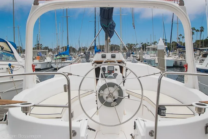 Slide: The Image of Cockpit view of a 1999 Hunter 340 sailboat docked in a marina. - 5
