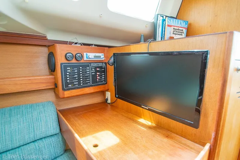 Slide: The Image of Interior of a 1999 Hunter 340 sailboat with control panel and TV. - 20