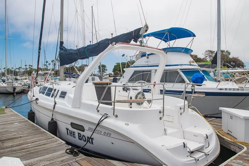 Slide: The Image of Hunter 340 sailboat from 1999 docked at a marina, surrounded by other boats. - 2